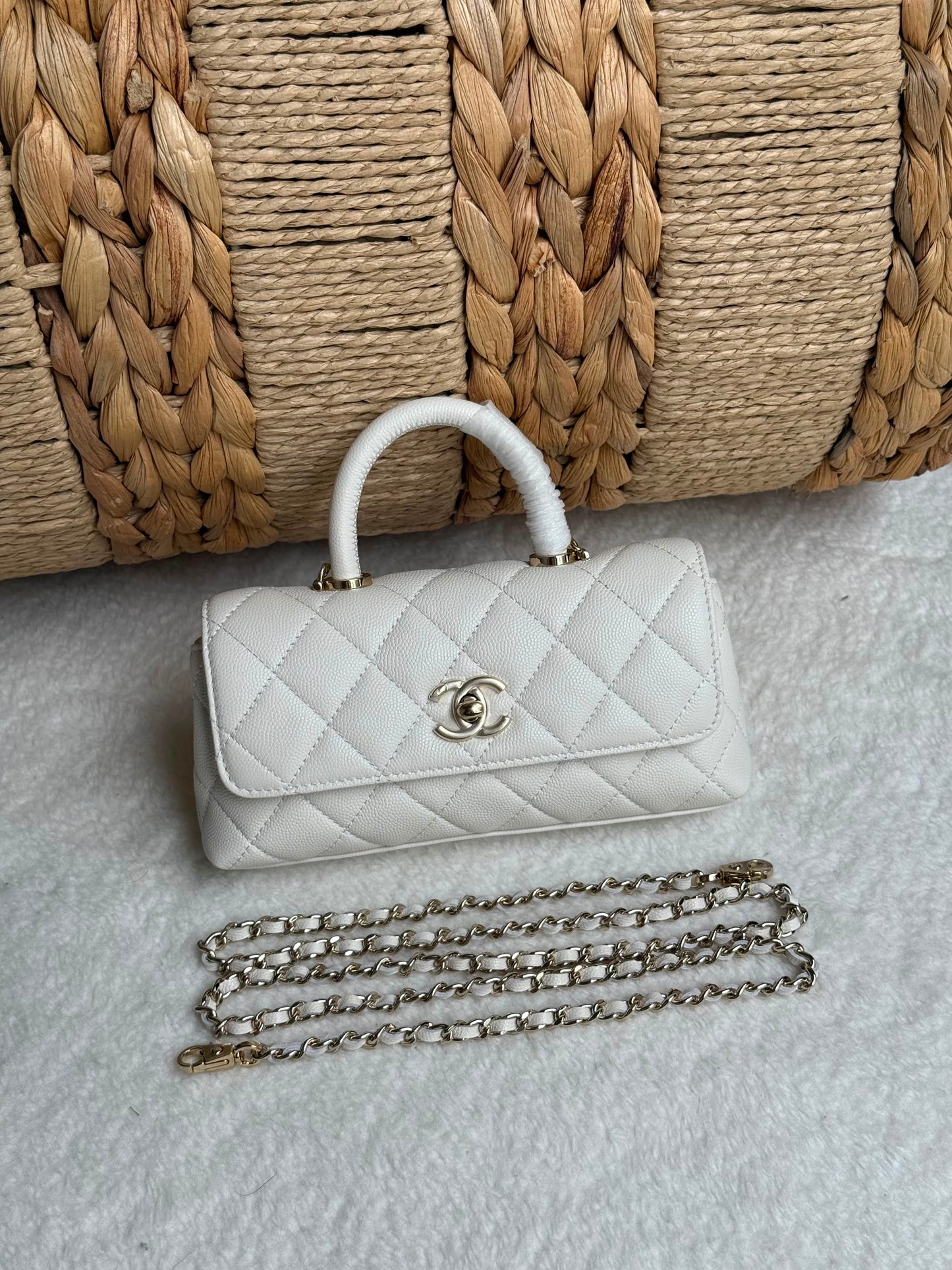 caviar leather Chanel Coco Handle Bag features a top handle