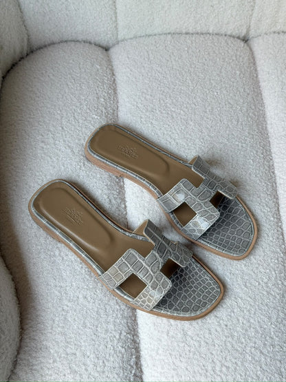 Hermès Oran sandals in crocodile-embossed leather