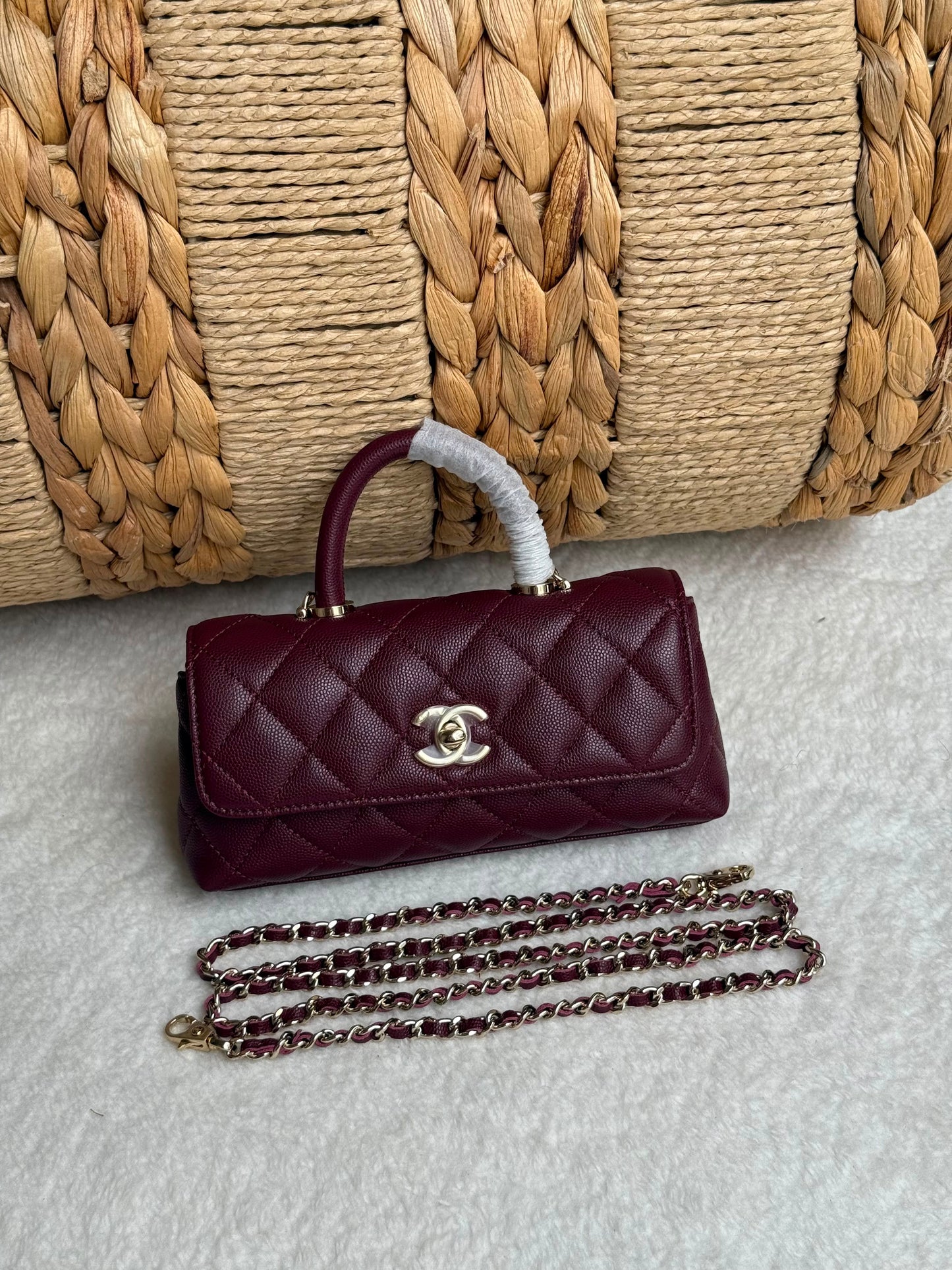 caviar leather Chanel Coco Handle Bag features a top handle