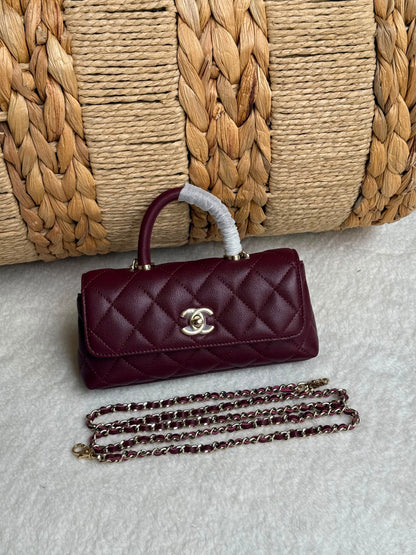 caviar leather Chanel Coco Handle Bag features a top handle