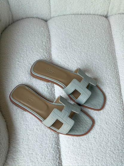 Hermès Oran sandals in crocodile-embossed leather