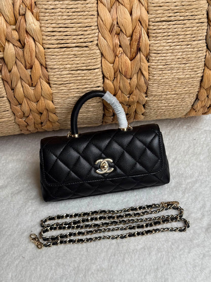 caviar leather Chanel Coco Handle Bag features a top handle