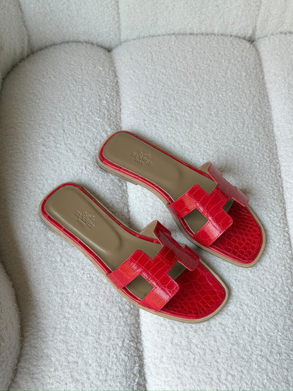 Hermès Oran sandals in crocodile-embossed leather