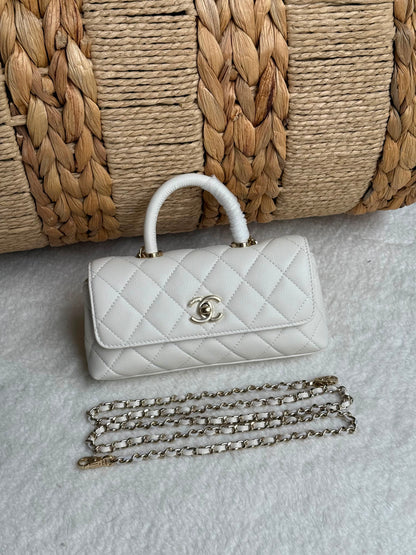 caviar leather Chanel Coco Handle Bag features a top handle